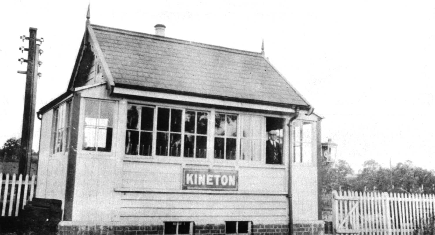 Signalman Charles Neal poses for the camera at the window of his neat and well kept signal box at Kineton station