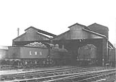 Ex-MR 4F 0-6-0 No 3895 stands fully coaled outside the shed alongside an LMS 4F 0-6-0 on 23rd March 1947