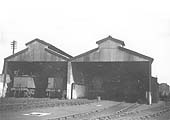 View of the four road shed showing locomotives inside the shed and the siding alongside the outer wall