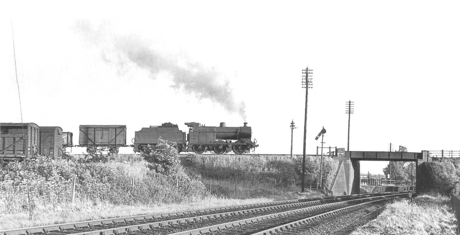 Ex-LMS 0-6-0 4F No 44043 is seen on a down freight about to cross the former GWR lines on 11th June 1957