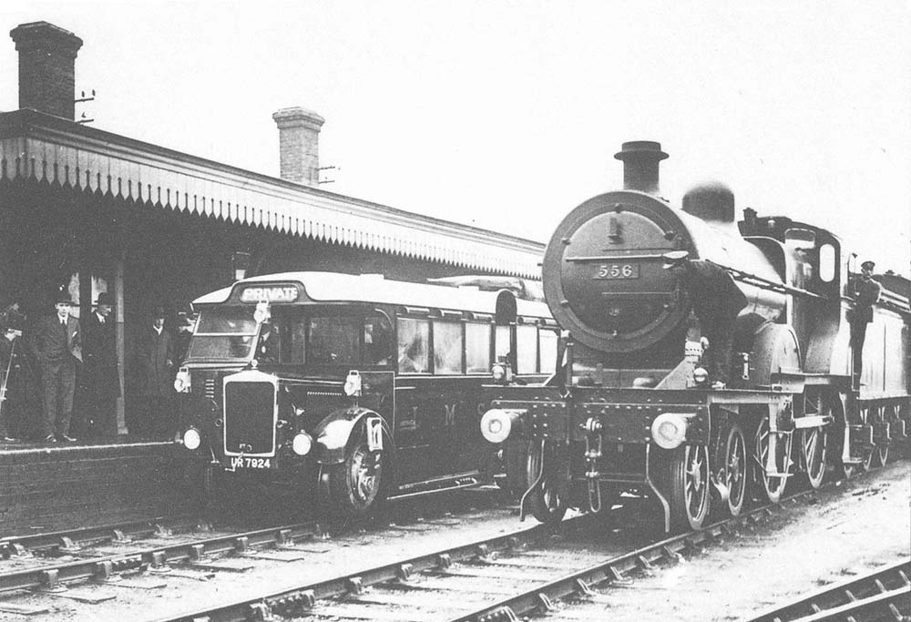 The Ro-Railer is standing at the up platform whilst ex-MR 4-4-0 No 556 stands on the middle road