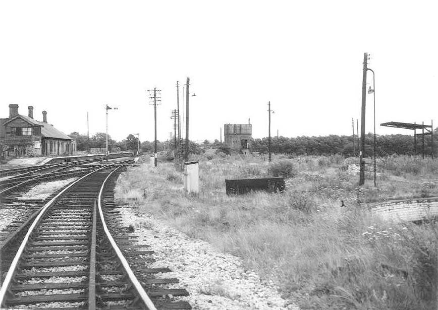 View taken on 18th August 1962 of the abandoned station and demolished shed from the down spur to the former GWR line to Honeybourne