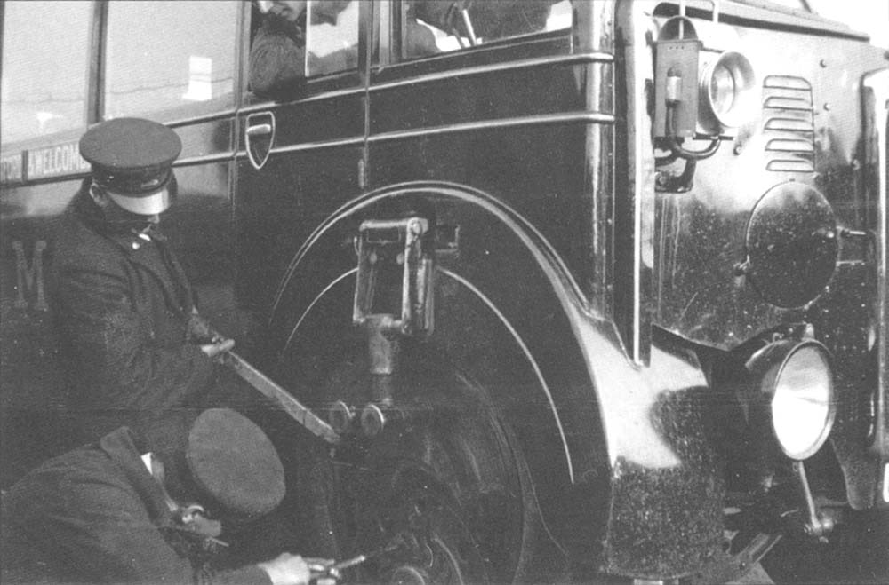 The crew of the Ro-Railer are seen changing the wheels configuration from travelling on the road to travelling on the rails