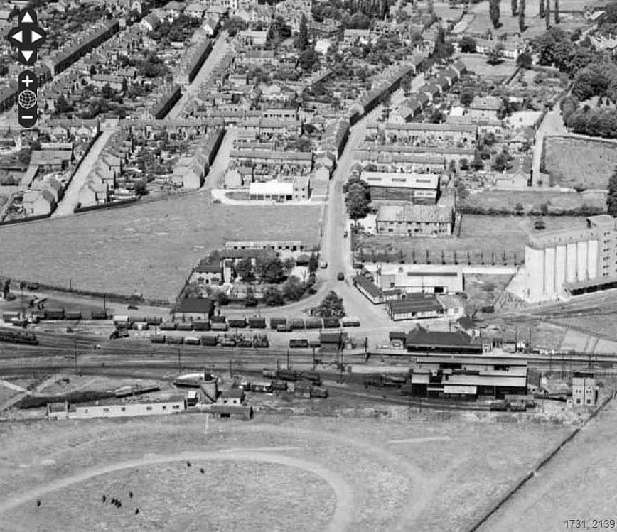 An aerial view showing the approach via New Street to Stratford Old Town station, goods yard and shed on 23rd June 1952
