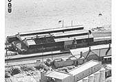 An aerial view of Stratford Old Town's locomotive shed showing the section of roof without its corrugated sheeting on 23rd June 1952
