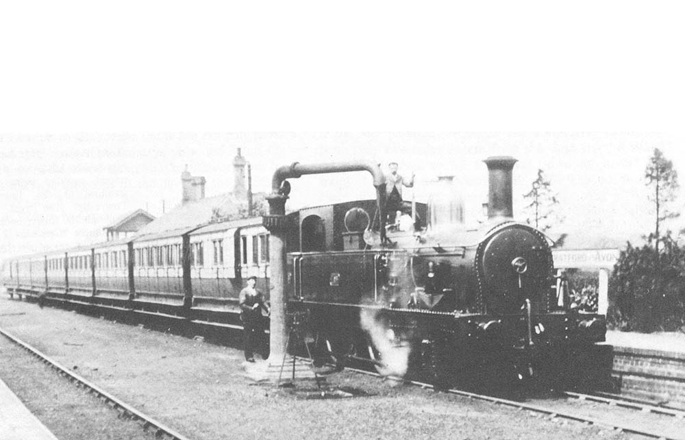 E&WJR 2-4-0T No 5 pauses with a eight-coach special train at the east end of the up platform to top up the tanks with water