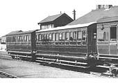 SMJ six-wheel coaches, displaying the company's maroon livery, stand on the up line at Stratford station