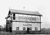 View of Braunston & Willoughby station's signal cabin with staff posing for the camera circa 1910