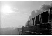 Ex-WD 'Austerity' 2-8-0 No 90448 crosses Catesby viaduct heading into a wintry sun on the long drag up to the tunnel