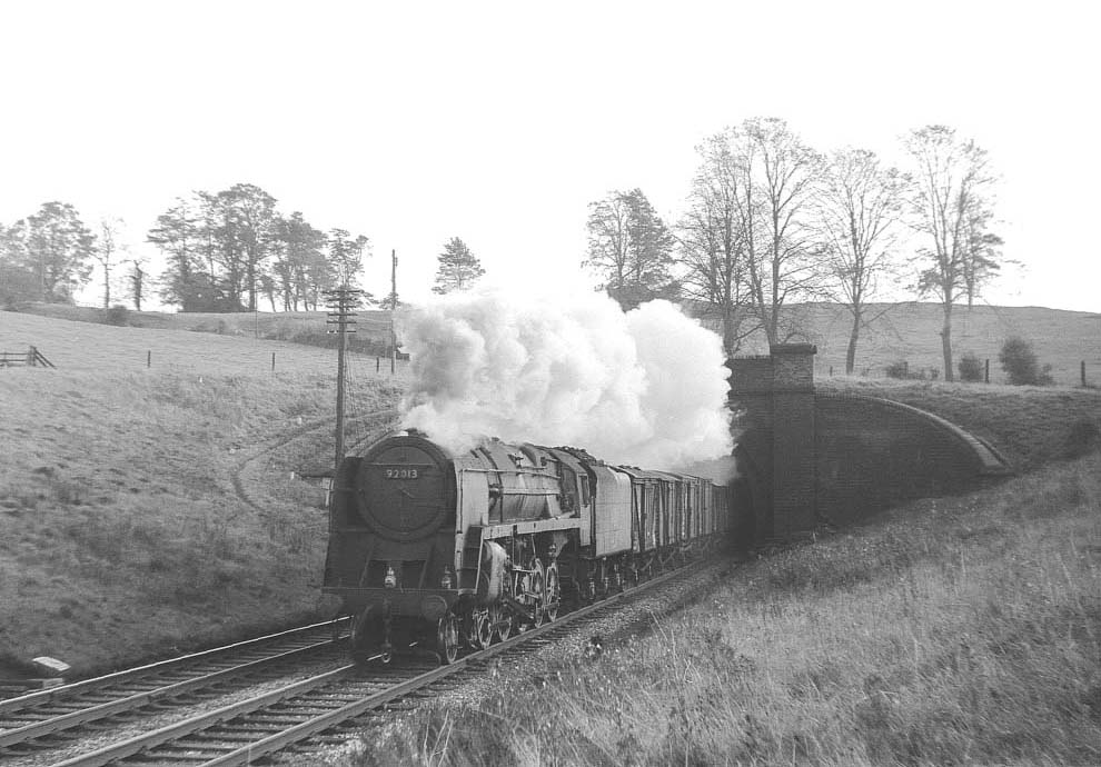 British Railways Standard Class 9F 2-10-0 No 92013 exits the north portal of Catesby tunnel, in the summer of 1963