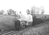 British Railways Standard Class 9F 2-10-0 No 92013 exits the north portal of Catesby tunnel, in the summer of 1963