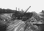 A steam powered navvy, built by Whitaker & Sons of Leeds, is seen working in a deep cutting near Rugby