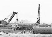 View of ex-LNER 2-6-2 Class V2 No 60828 being lifted by two railway cranes back on to the track