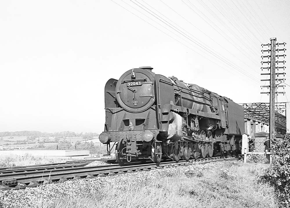 British Railways Standard Class 9F 2-10-0 No 92043 crosses the GCR bridge over the West Coast main line on 12th October 1963