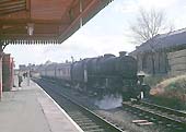 An unidentified ex-LMS 'Black Five' 4-6-0 stands on the passing loop line waiting for an express to Nottingham