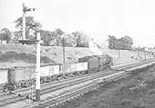 An unidentified British Railways Standard Class 9F locomotive is seen working hard on an up coal train during 1963