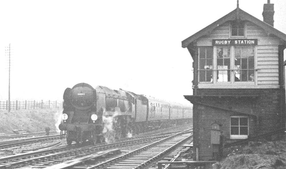 Ex-Southern Railways West Country class 4-6-2 No 34042 'Dorchester' on a football cup special passes Rugby Signal Box in March 1963 on its way to Nottingham