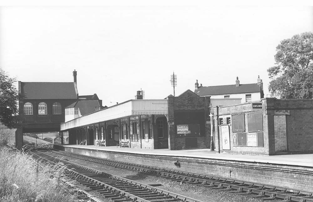 Looking towards Leicester showing the down platform and the booking hall and offices spanning the tracks