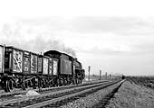An unidentified British Railways Standard Class 5 4-6-0 locomotive rattles passed with an empty mineral train at Barby
