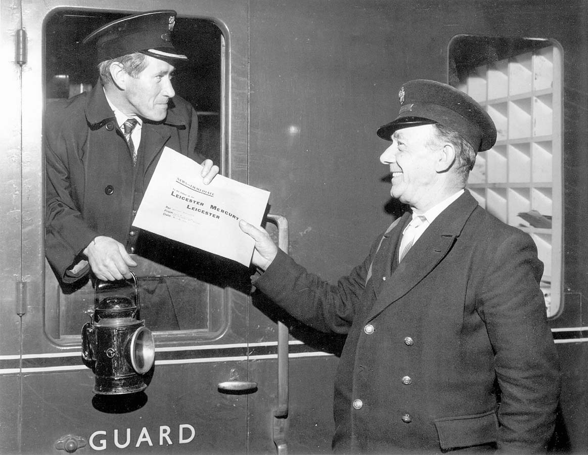 British Railways guard John Magee, working his last week at Rugby Central station, receives a Leicester Mercury news packet