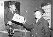 BR guard John Magee, receives a Leicester Mercury news packet whilst working his last week at Rugby station