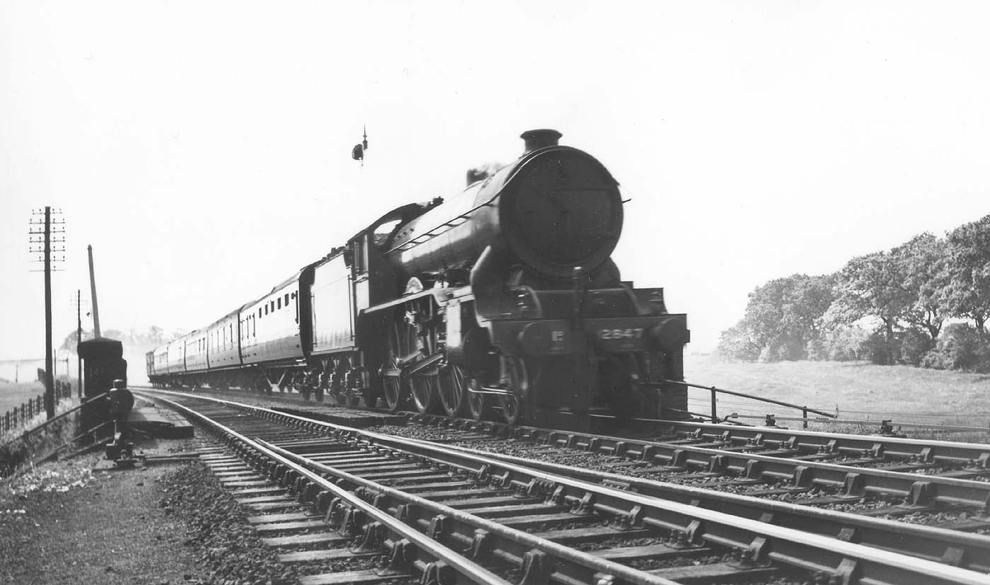 LNER 4-6-0 Class B17/4 No 2847 'Helmingham Hall' passes over Staverton Road on a down express service