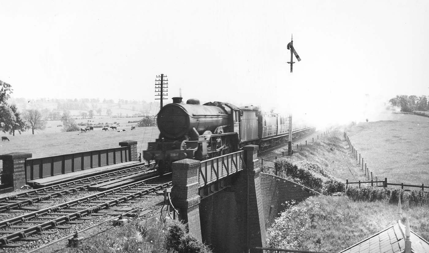 LNER 4-6-0 Class B17/4 No 2848 'Arsenal' roars across Staverton Road on a down express in June 1939