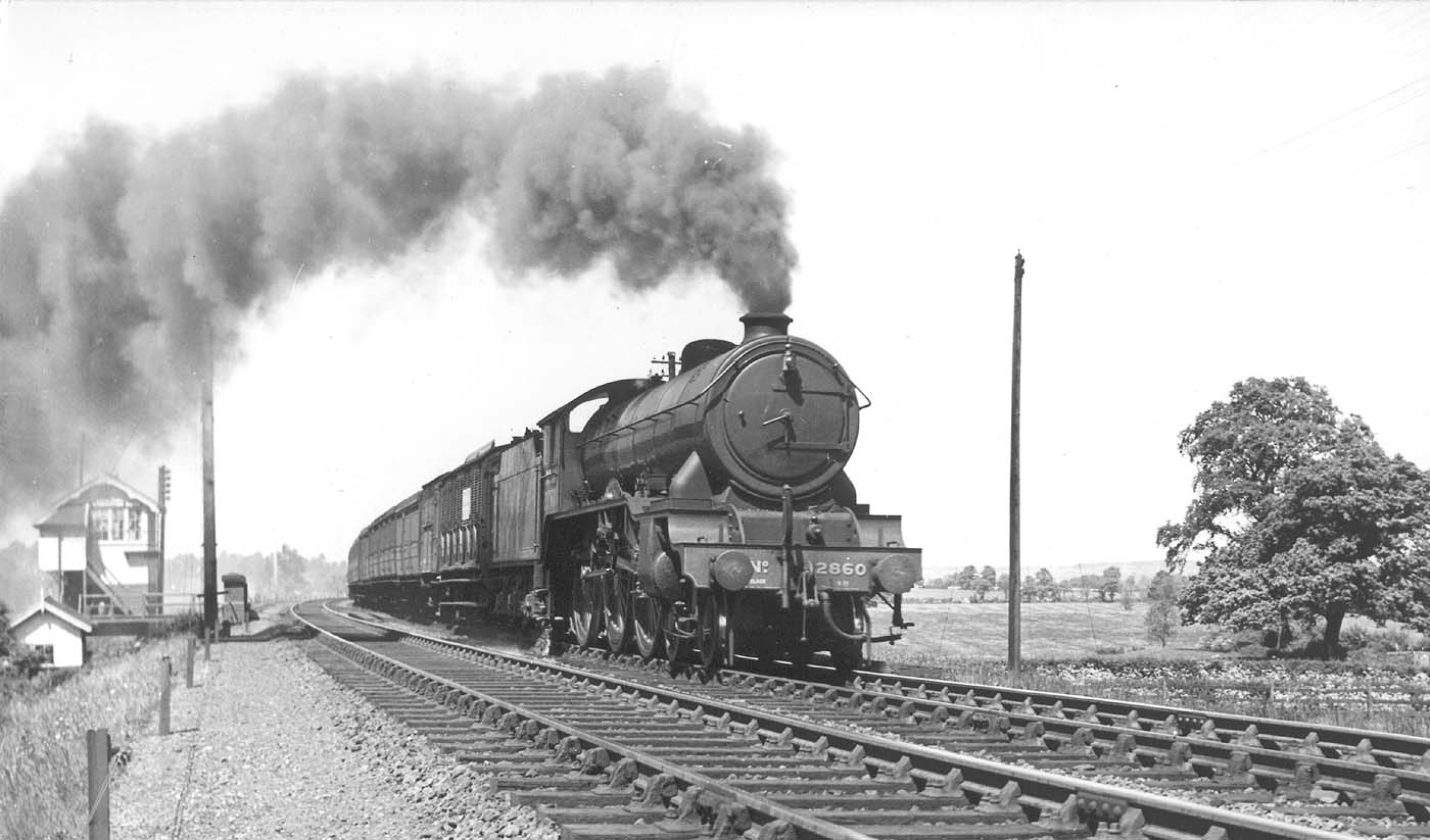 LNER 4-6-0 Class B17/4 No 2860 'Hull City' throws out a lot of unburnt coal as it passes Staverton Road signal cabin in 1946