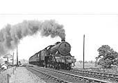LNER 4-6-0 Class B17/4 No 2860 'Hull City' throws out unburnt coal as it passes Staverton Road signal cabin