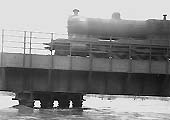 A Great Western Railway 30xx class 2-8-0 locomotive crosses a swollen river Avon during the 1947 floods