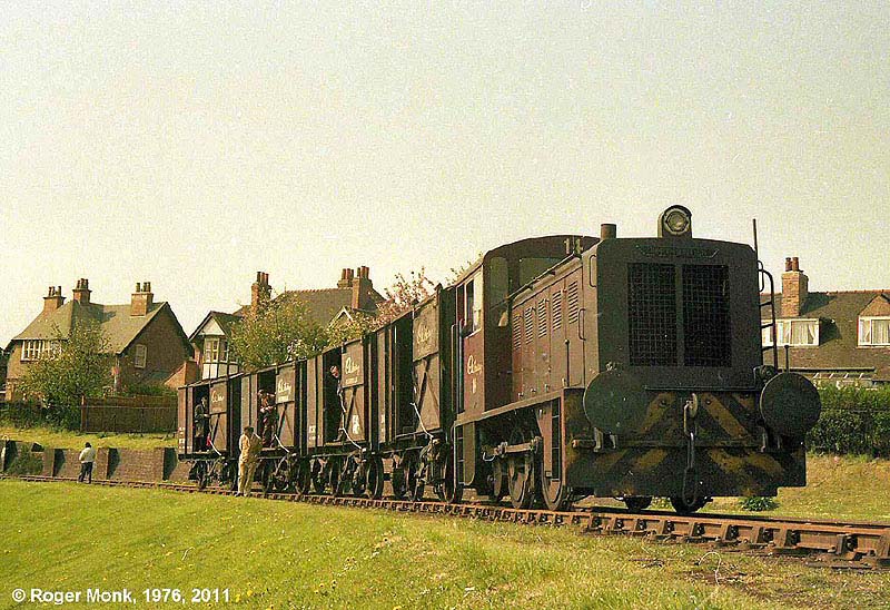 No 14 pauses with the railtour train within the well kept grounds of the works on the incline approaching the skew bridge
