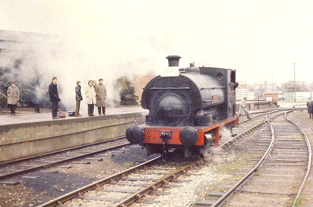 Railway enthusiasts on a platform watch Peckett 0-4-ST, Works No 1722, 'Rocket', steam by on 8th April 1972
