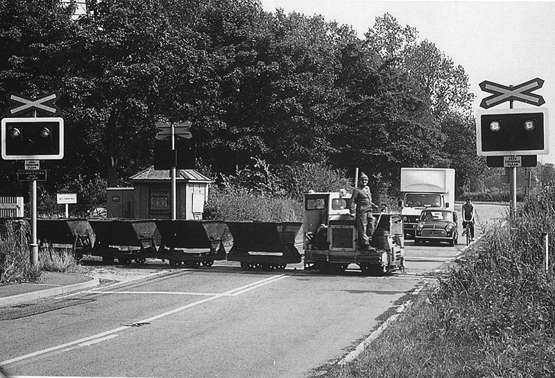 Motor Rail 40SD501 is seen crossing Water Orton Lane at the head of empty skips at Minworth Sewage Works