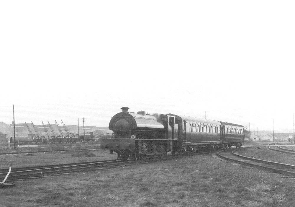 War Department 0-6-ST No 160 is seen within Long Marston Ordnance Depot at the head of a two coach train