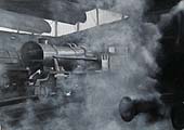 Ex-WD 2-8-0 'Stanier' 8F No 48292 stands inside Saltley shed amidst the smoke, steam and gloom