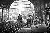 Passengers patiently wait for the next train to arrive at a draughty cold Platform 10 in New Street Station in the early 1960s